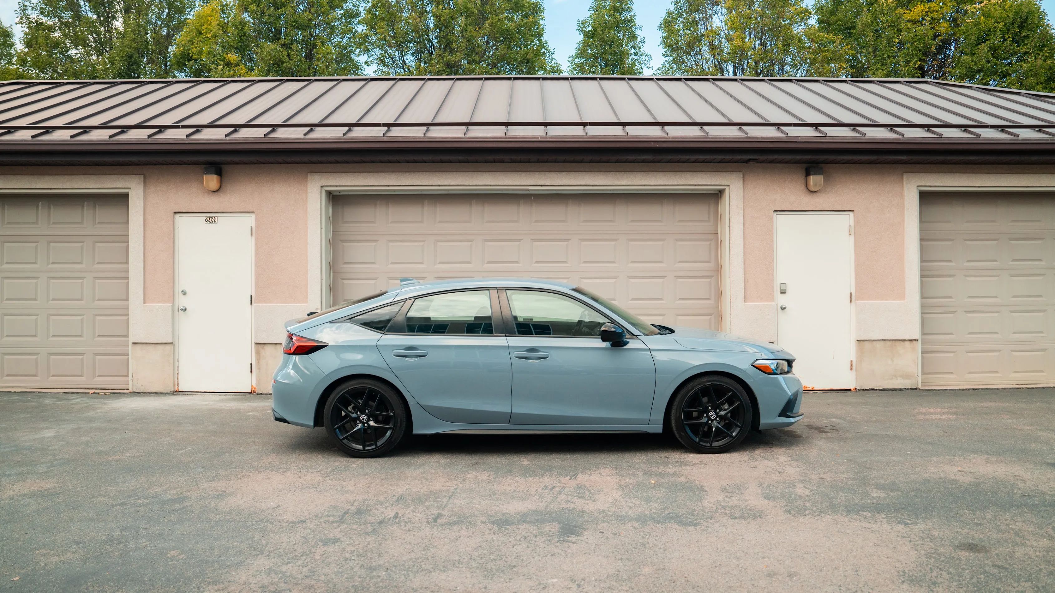 Car parked in front of garage doors 